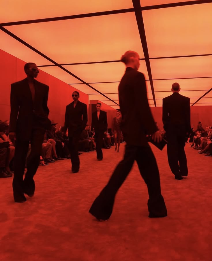 Guests moving through a red-lit installation room